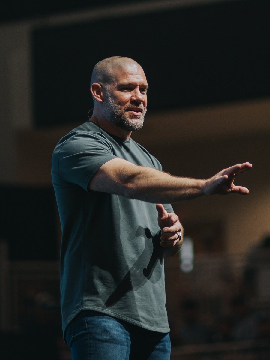 James Griffin preaching on stage. Opens bio.