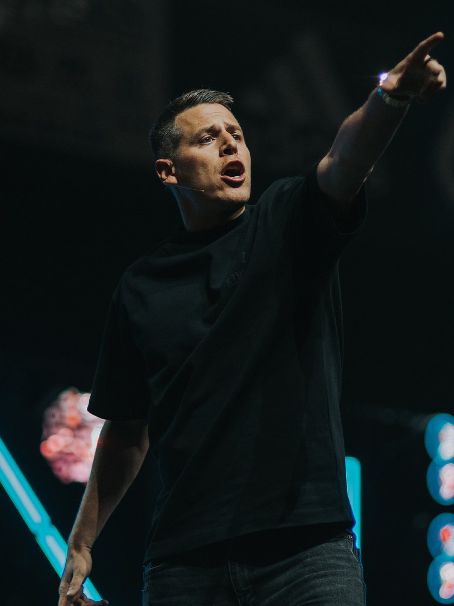 Matt Chewning preaching on stage. Opens bio.
