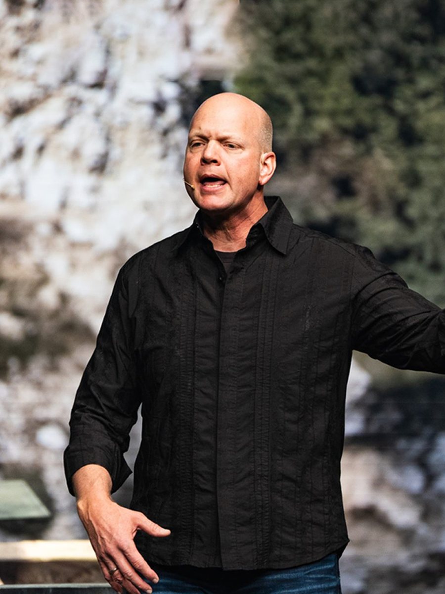 Phil Hopper preaching on stage. Opens bio.